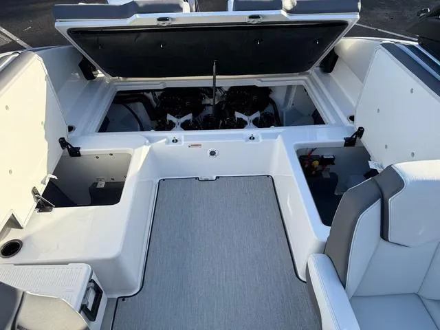 Slide: The Image of 2025 Yamaha Boats AR250 interior with open engine compartment and seating. - 11