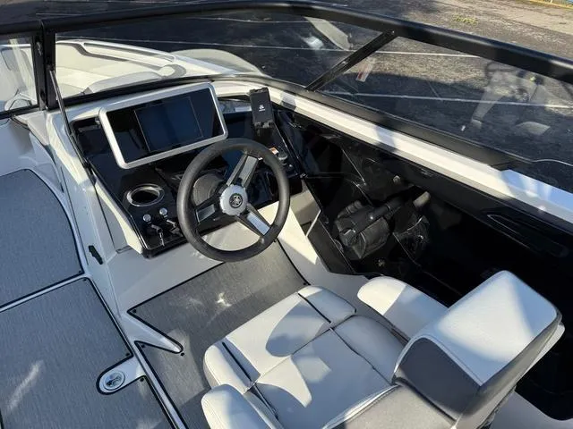 Slide: The Image of 2025 Yamaha Boats AR250 cockpit with modern steering and navigation system. - 12