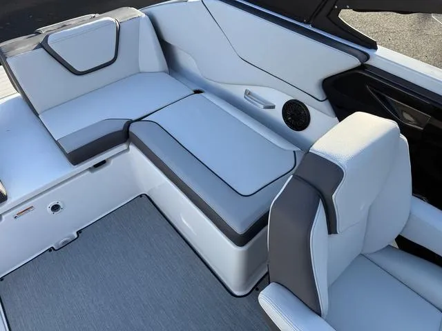 Slide: The Image of 2025 Yamaha Boats AR250 interior with sleek white and gray seating design. - 5