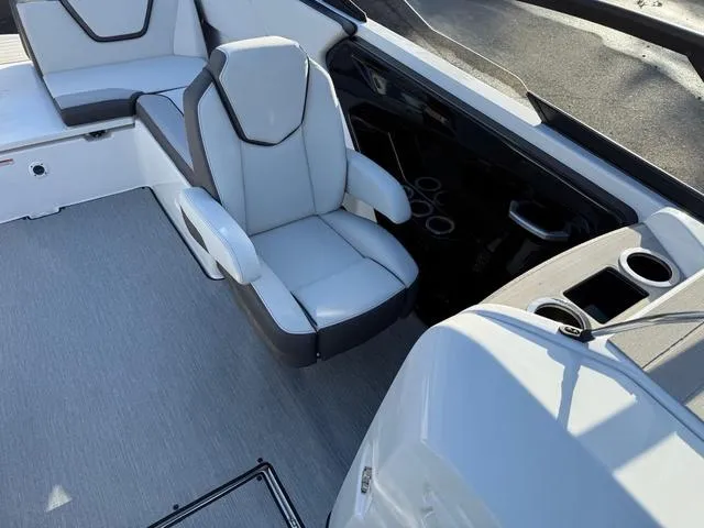 Slide: The Image of 2025 Yamaha Boats AR250 interior with modern seating and cup holders. - 7