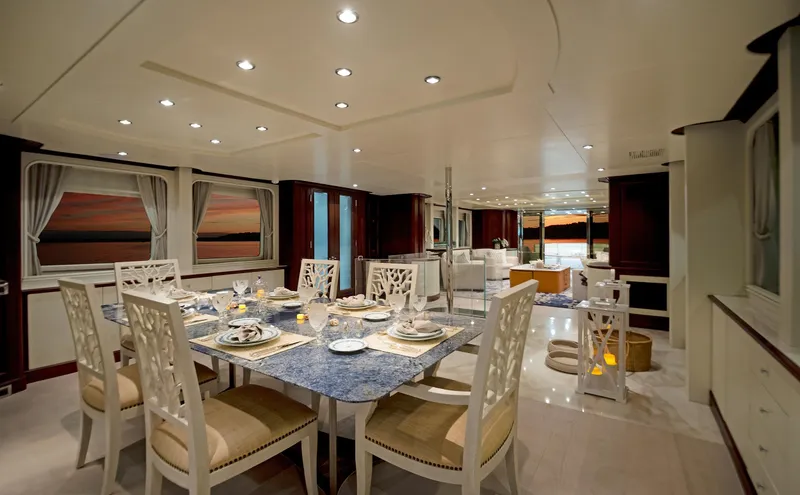 Slide: The Image of Luxurious dining area on 2003 Benetti 115 Classic yacht, elegant table setting, sunset view. - 10
