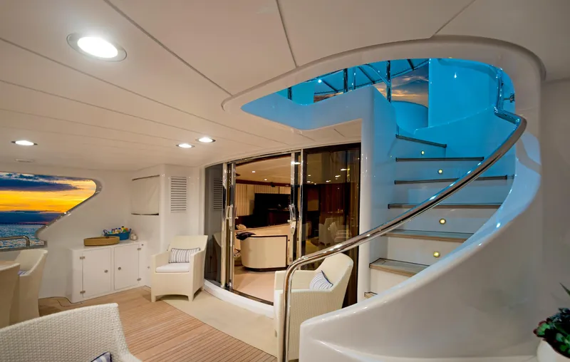 Slide: The Image of Luxurious interior of 2003 Benetti 115 Classic yacht with elegant staircase and seating area. - 11