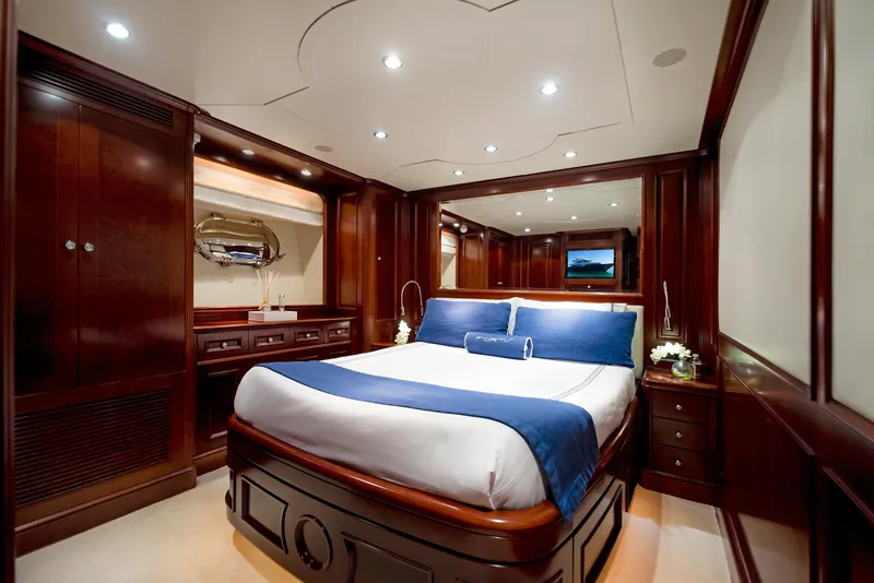 Slide: The Image of Luxurious bedroom interior on 2003 Benetti 115 Classic yacht with elegant wood finishes. - 17