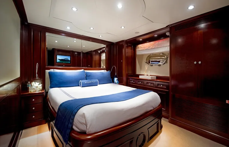 Slide: The Image of Luxurious bedroom interior on 2003 Benetti 115 Classic yacht with elegant wood finishes. - 19