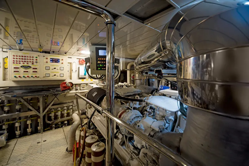 Slide: The Image of Engine room of 2003 Benetti 115 Classic yacht, featuring control panels and machinery. - 23