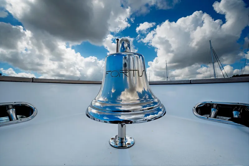 Slide: The Image of Shiny bell on Benetti 115 Classic yacht, 2003, under cloudy sky. - 24
