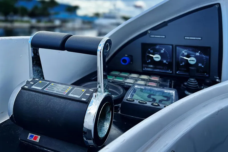 Slide: The Image of Control panel of a 2003 Benetti 115 Classic yacht, featuring throttle and gauges. - 25