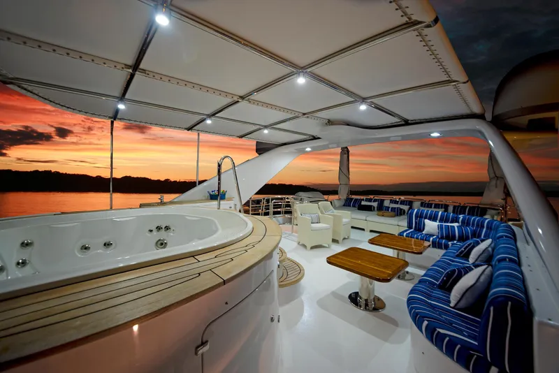 Slide: The Image of Luxurious Benetti 115 Classic yacht deck with jacuzzi at sunset, 2003 model. - 4