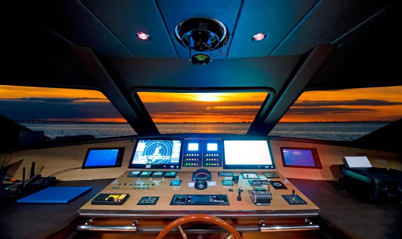 Slide: The Image of Bridge of 2003 Benetti 115 Classic yacht at sunset, featuring advanced navigation controls. - 7