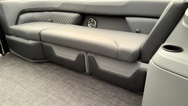 Slide: The Image of 2025 Godfrey Pontoons Sweetwater 2286 SB interior seating with gray upholstery and speaker. - 18