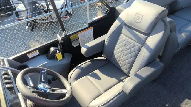 Slide: The Image of 2025 Godfrey Pontoons Sweetwater 2286 SB GTP interior with luxury captain's chair and steering wheel. - 21