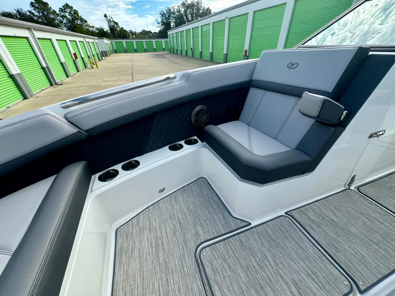 Slide: The Image of 2022 Cobalt R8 Outboard boat interior with gray seating and cup holders. - 28