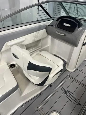 Slide: The Image of 2022 Chaparral 23 SSi boat interior with modern seating and dashboard. - 11