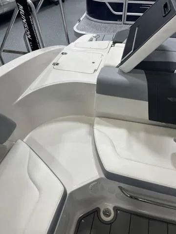 Slide: The Image of 2022 Chaparral 23 SSi boat interior with steering wheel and white seating. - 6