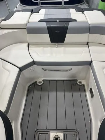 Slide: The Image of 2022 Chaparral 23 SSi boat interior with sleek seating and modern dashboard design. - 8