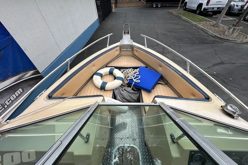 Slide: The Image of 1987 Seaswirl Sierra II boat interior with life preserver and rope on deck. - 15