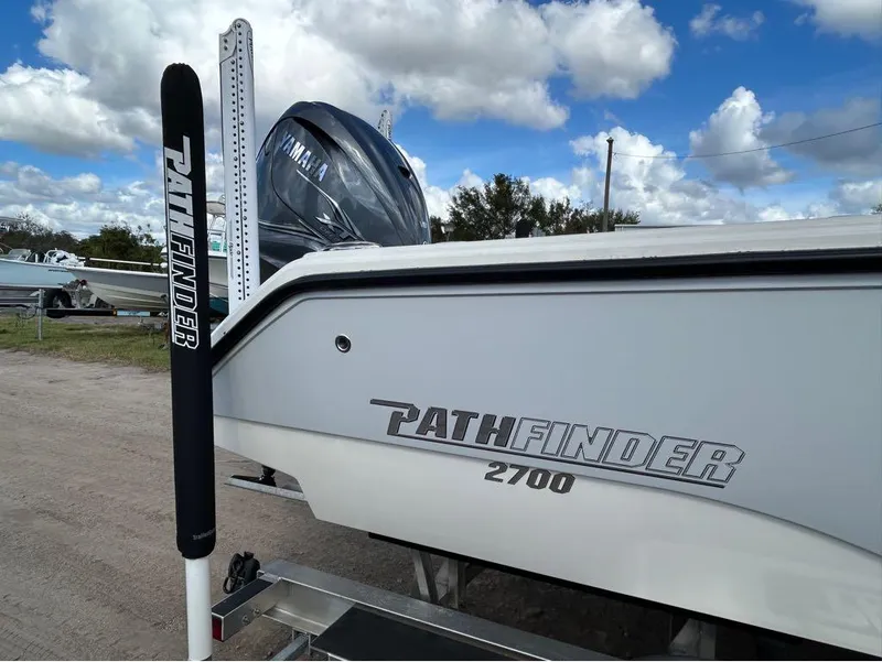 Slide: The Image of 2025 Pathfinder 2700 Open boat with Yamaha engine, parked outdoors under cloudy sky. - 15
