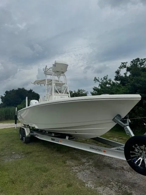 Slide: The Image of 2025 Pathfinder 2700 Open boat on trailer under cloudy sky. - 16