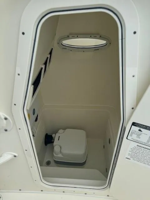 Slide: The Image of 2025 Pathfinder 2700 Open boat interior with compact marine toilet. - 2