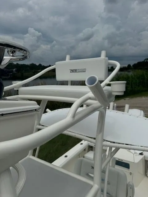 Slide: The Image of 2025 Pathfinder 2700 Open boat with white seating and rod holders under cloudy skies. - 5