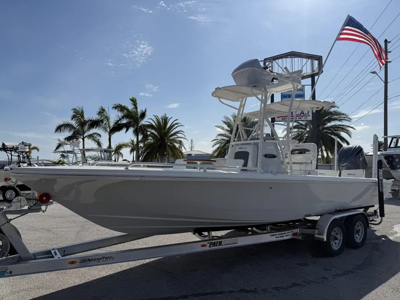Slide: The Image of 2025 Pathfinder 2600 TRS boat on trailer, palm trees and American flag in background. - 1