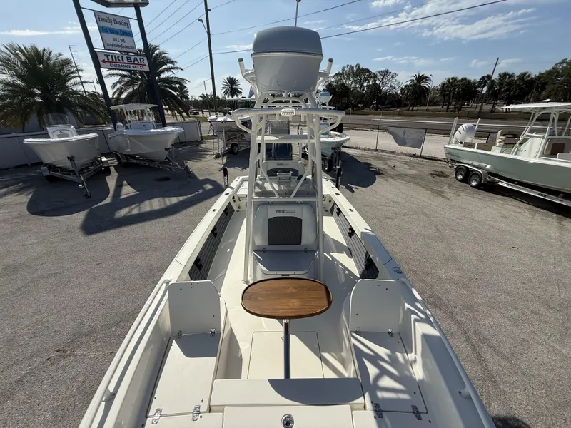 Slide: The Image of 2025 Pathfinder 2600 TRS boat at a marina with palm trees and signage. - 12