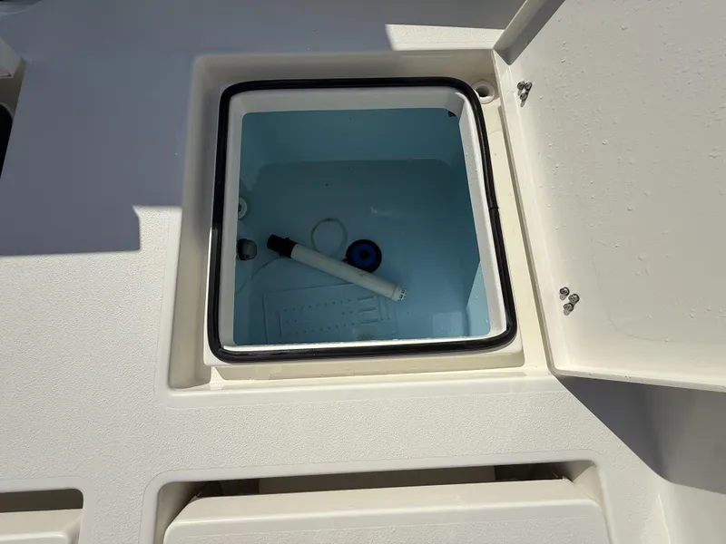 Slide: The Image of Open storage compartment on 2025 Pathfinder 2600 TRS boat, showing interior details. - 15