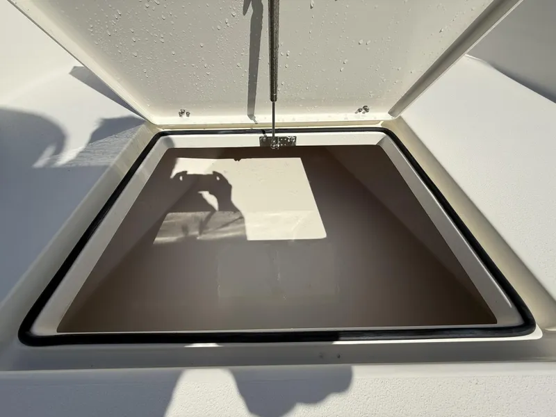 Slide: The Image of Open hatch on 2025 Pathfinder 2600 TRS boat, showing interior storage space. - 19