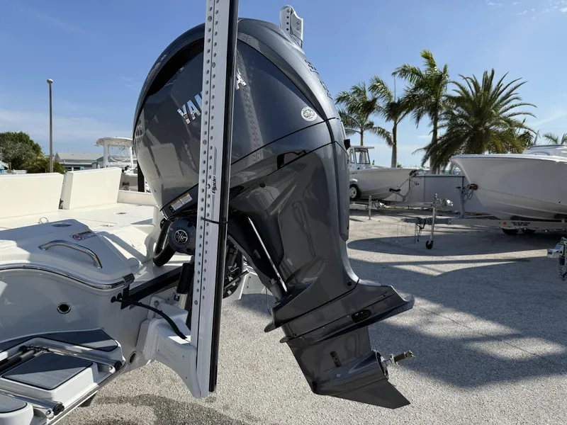 Slide: The Image of 2025 Pathfinder 2600 TRS boat with Yamaha outboard motor, parked near palm trees. - 25