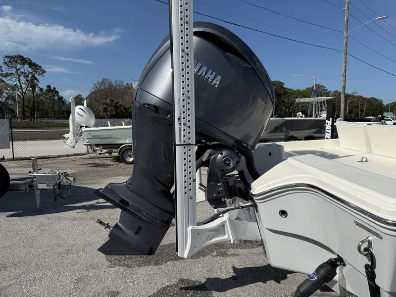 Slide: The Image of 2025 Pathfinder 2600 TRS boat with Yamaha outboard motor in a parking lot. - 26