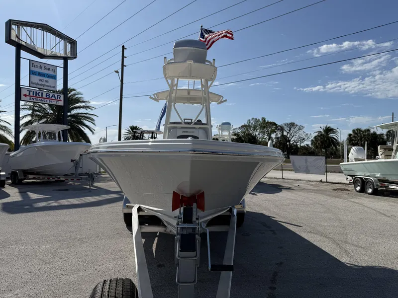 Slide: The Image of 2025 Pathfinder 2600 TRS boat on trailer at marina with American flag. - 28