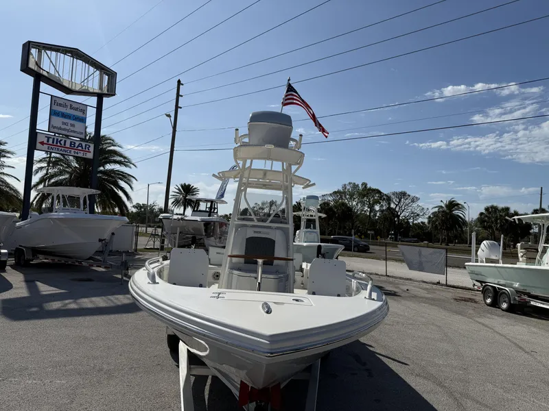 Slide: The Image of 2025 Pathfinder 2600 TRS boat displayed at a marina with palm trees and signage. - 29