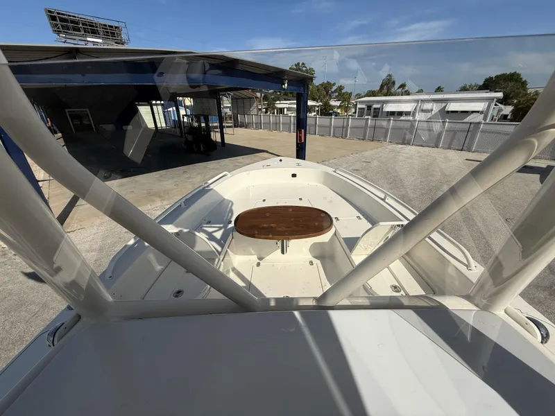 Slide: The Image of 2025 Pathfinder 2600 TRS boat with wooden table, docked in a marina. - 33