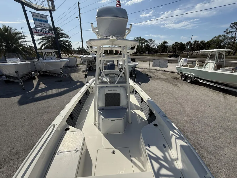 Slide: The Image of 2025 Pathfinder 2600 TRS boat at dealership, surrounded by other boats, under clear sky. - 36