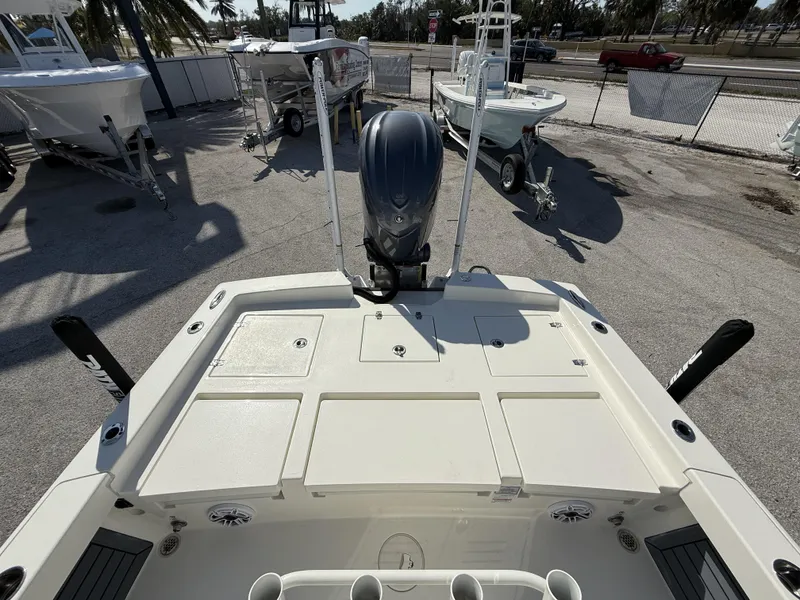 Slide: The Image of 2025 Pathfinder 2600 TRS boat with outboard motor, docked in a marina. - 39