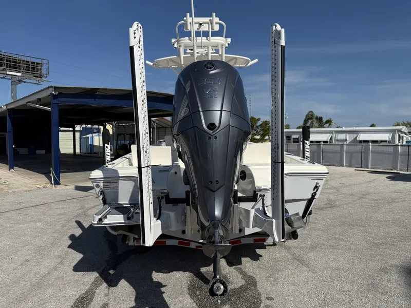 Slide: The Image of 2025 Pathfinder 2600 TRS boat with powerful outboard motor, parked on a sunny day. - 4