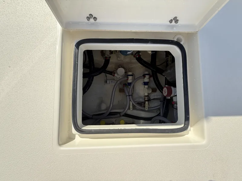 Slide: The Image of Open hatch of 2025 Pathfinder 2600 TRS boat showing internal wiring and components. - 43