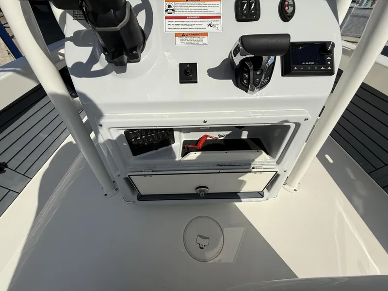Slide: The Image of 2025 Pathfinder 2600 TRS boat console with controls and storage compartment. - 44