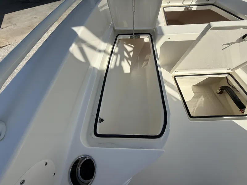 Slide: The Image of 2025 Pathfinder 2600 TRS boat storage compartments, open hatches, and sleek design. - 46