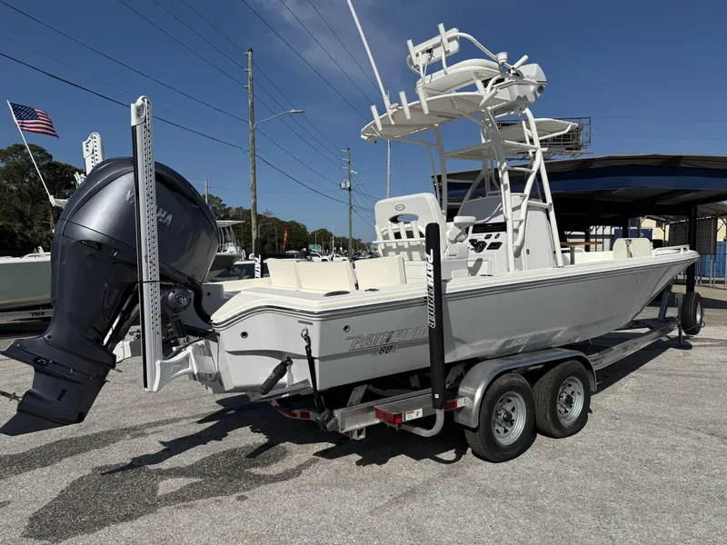 Slide: The Image of 2025 Pathfinder 2600 TRS boat on trailer with Yamaha outboard motor, parked outdoors. - 6