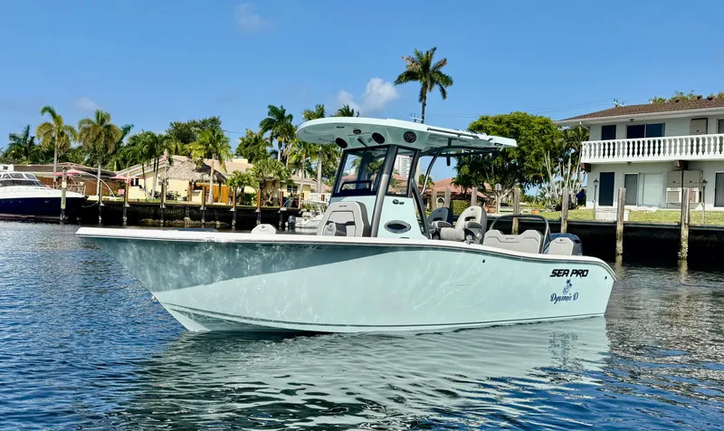 Slide: The Image of 2025 Sea Pro 245 FLX boat interior with dual seats and steering wheel. - 2