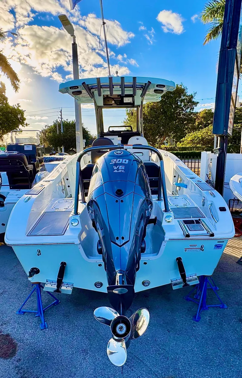 Slide: The Image of 2025 Sea Pro 245 FLX boat with powerful outboard motor, parked outdoors. - 22