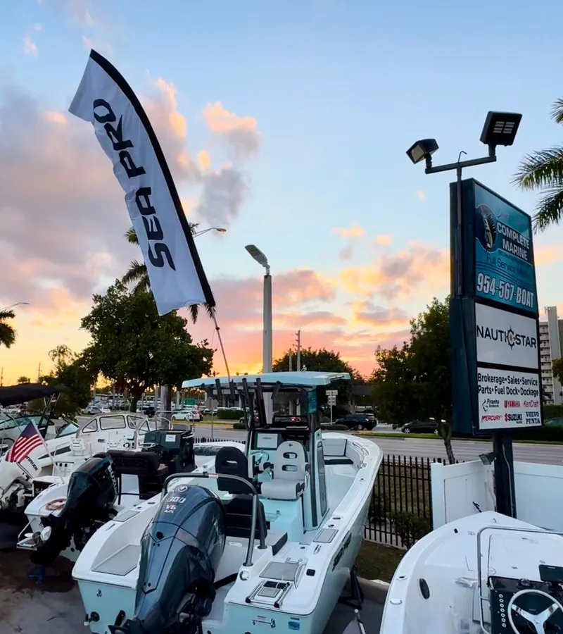 Slide: The Image of 2025 Sea Pro 245 FLX boat displayed at sunset in a marina. - 33