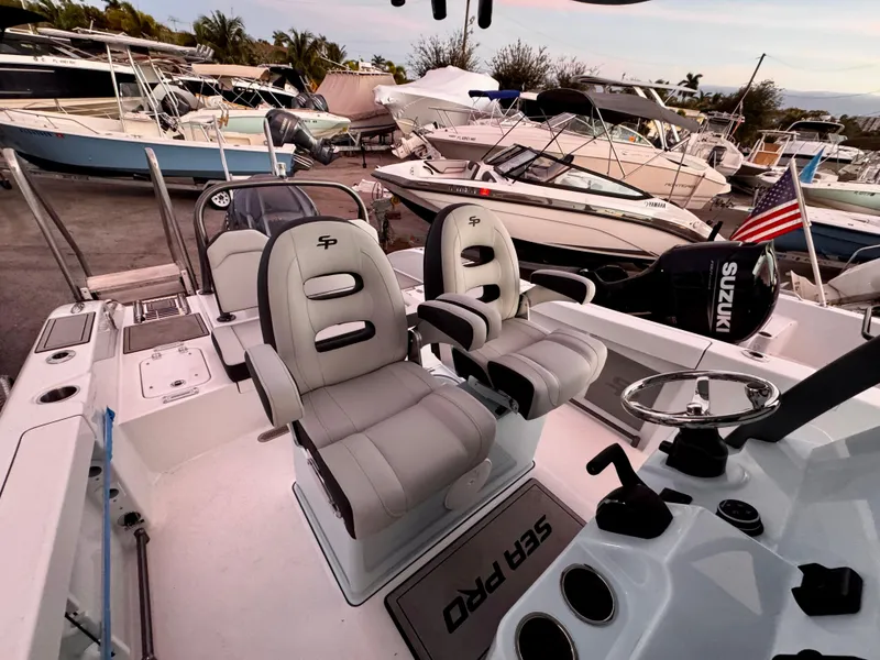 Slide: The Image of 2025 Sea Pro 245 FLX boat interior with dual seats and Suzuki engine. - 36