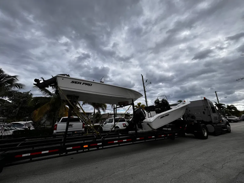 Slide: The Image of Sea Pro 245 FLX boat on trailer under cloudy sky, 2025 model. - 39