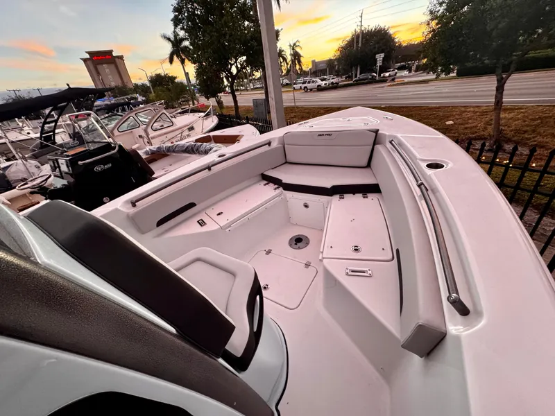 Slide: The Image of 2025 Sea Pro 245 FLX boat interior with seating, docked at sunset. - 4