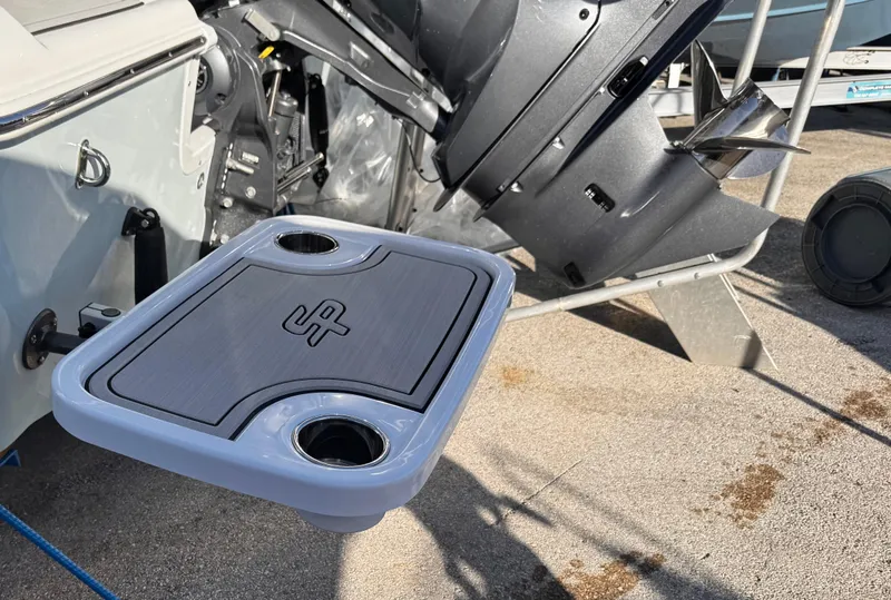 Slide: The Image of 2025 Sea Pro 245 FLX boat with a foldable table and cup holders. - 45