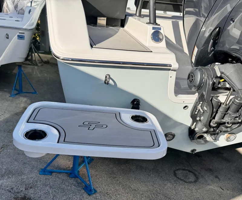 Slide: The Image of 2025 Sea Pro 245 FLX boat with mounted accessory table and cup holders. - 48