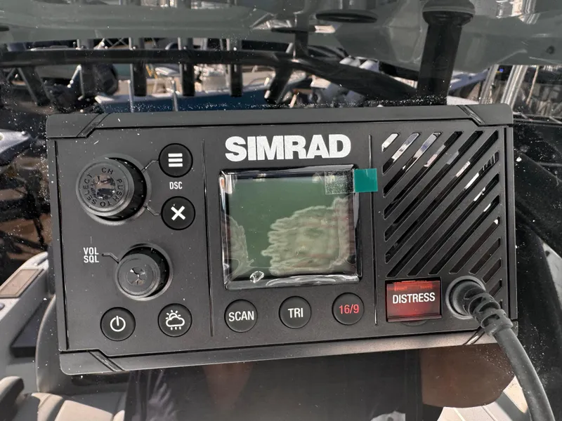 Slide: The Image of Simrad marine radio on 2025 Sea Pro 245 FLX boat dashboard. - 51