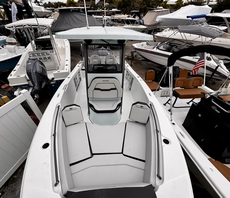 Slide: The Image of 2025 Sea Pro 245 FLX boat with sleek design at a marina. - 6